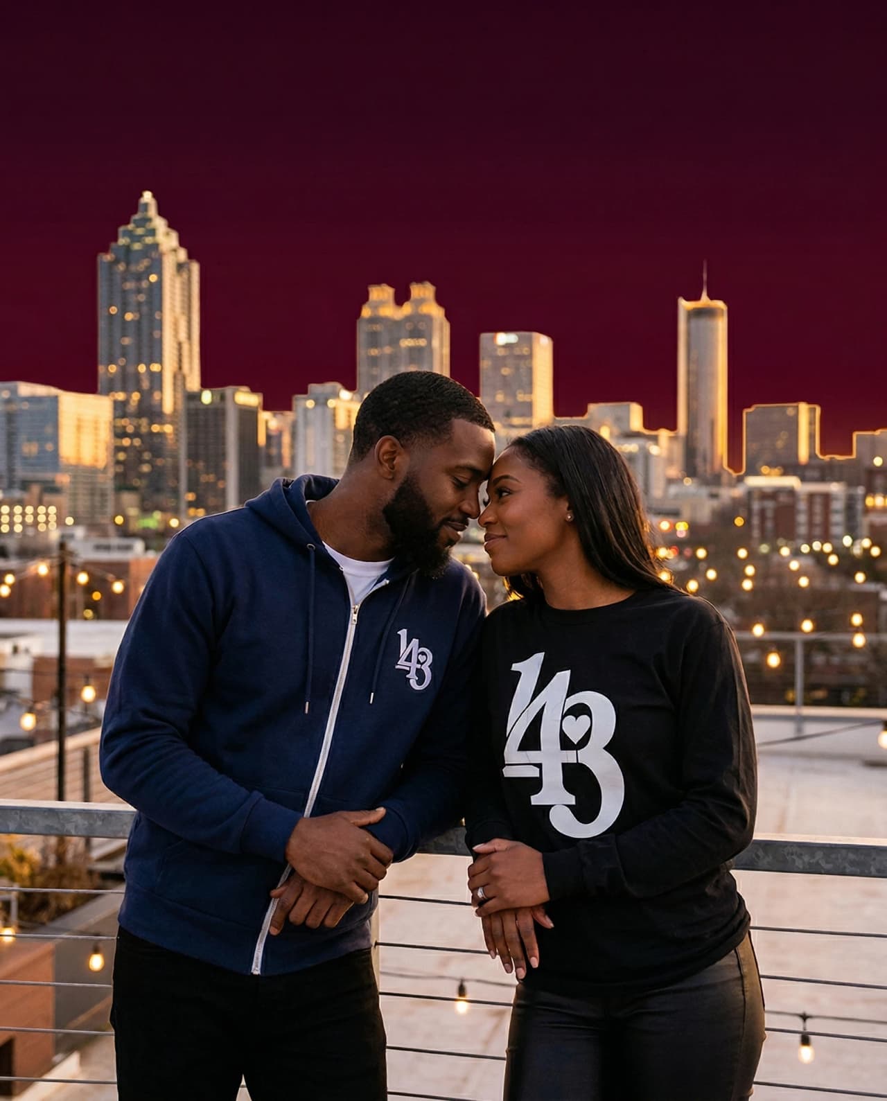 City couple on a rooftop night wearing 143 style